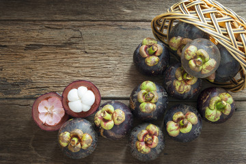 Fototapeta premium Mangosteen fruit on wood table with top view
