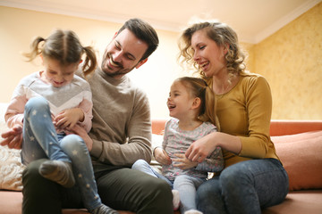 Obraz premium Happy family at home spending time together and playing. Family spending time together at home.