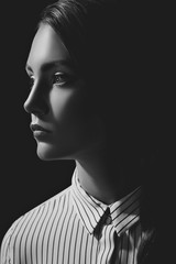 black and white portrait of pensive woman in shirt looking away