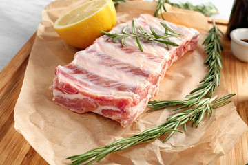 Raw ribs with rosemary on parchment