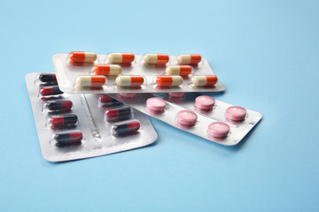 Different pills on color background