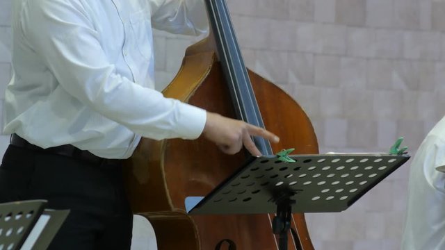 4k Close up of a man playing on cello on the stage.