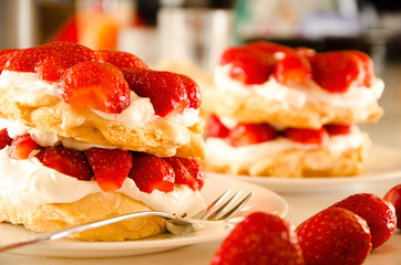 Homemade cream layer cake, fresh, colorful, and delicious dessert with juicy strawberries, sweet whipped cream and cream cheese