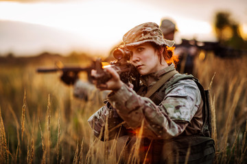 Rangers shooting with his weapon, rifle at sunset. War, army, military concept. - obrazy, fototapety, plakaty