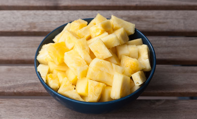 Pineapple slices in a blue ball on a wooden background