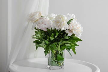 Bouquet of beautiful peony flowers on table