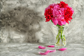 Bouquet of beautiful peony flowers on grunge background
