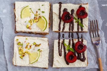 Raw pistachio, coconut, lime and chocolate-cherry cheesecakes. Love for a healthy vegan food concept.