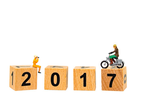 Miniature people,woman looking for traveler riding on wooden calendar isolated on white background using as human resource concept
