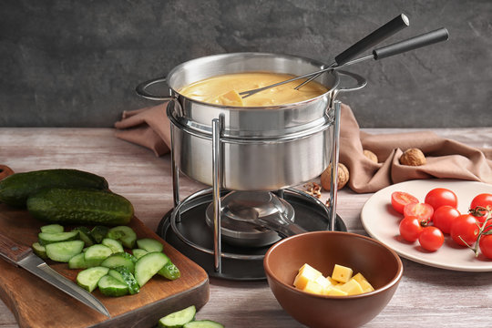 Delicious Cheese Fondue And Vegetables On Table