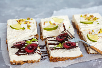 Raw pistachio, coconut, lime and chocolate-cherry cheesecakes. Love for a healthy vegan food concept.