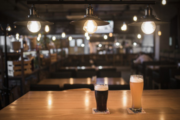 Light and dark beer in glasses on the table in the bar