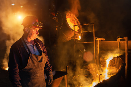 Foundry Worker Looking At Falling In Molten Steel.