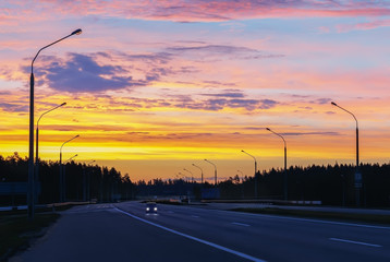 Rising sun on a dawn summer morning on the road.