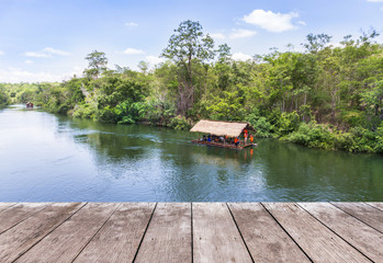 Fototapeta na wymiar Empty perspective old wooden balcony terrace floor with bamboo raft hut floating in river background