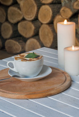 Coffee cup on bar table and romantic candles closeup
