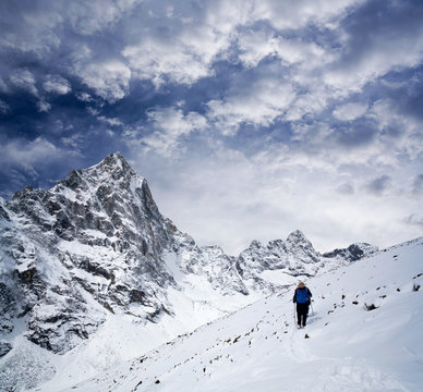 An unidentified hiker walking on the road to Everest Base Camp in Sagarmatha National Park, Nepal Himalaya