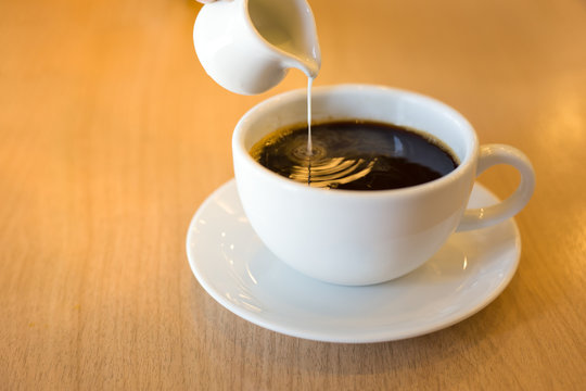 Pouring Condensed Milk Into The Coffee.