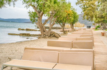 Beach with sun beds on the shore, Greece, island Crete