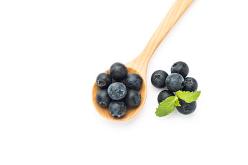 Fresh blueberries in wooden spoon on white background
