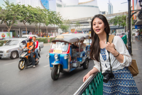Woman tourist standing in busy bangkok street
