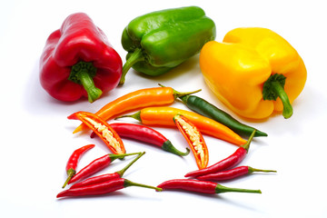 Red green yellow sliced chilli bell and bird's eye pepper isolated on white background
