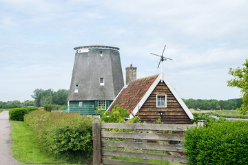 Fototapeta na wymiar Traditional Dutch windmills with canal near the Amsterdam, Holland