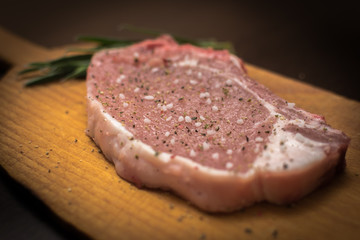Obraz na płótnie Canvas Raw pork with salt pepper and rosmary
