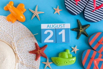 August 21st. Image of August 21 calendar with summer beach accessories and traveler outfit on background. Summer day, Vacation concept