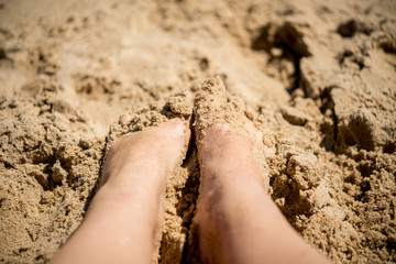 Woman feet in sand - relaxing on beach 
