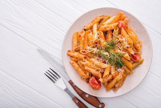 delicious penne pasta on wood white table