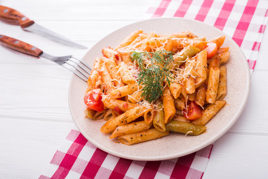 delicious penne pasta on wood white table