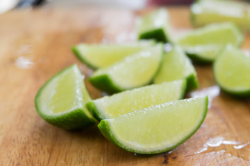 Limes Slice on Wooden Chopping Board in Kitchen