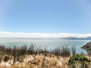 View of Golden Gate Bridge in foggy clouds from Angel Island