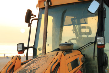 Backhoe working on the beach