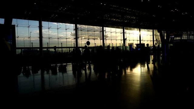 silhouettes of travellers in airport. Borderless world of business, communication and connection