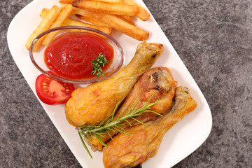 grilled chicken leg with french fries and ketchup