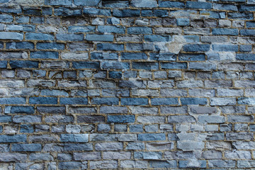 Ruined wall of brick gray.