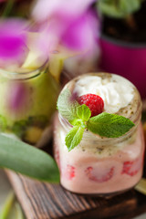 Layered berry and chia seeds smoothies and exotic fruit salad