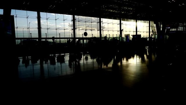 silhouettes of travellers in airport. Borderless world of business, communication and connection