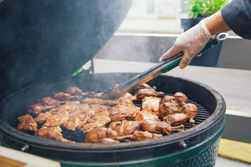 A person cooks meat for barbecue for guests, friends. Dining Eating Concept. Food Buffet. Catering Dining.
