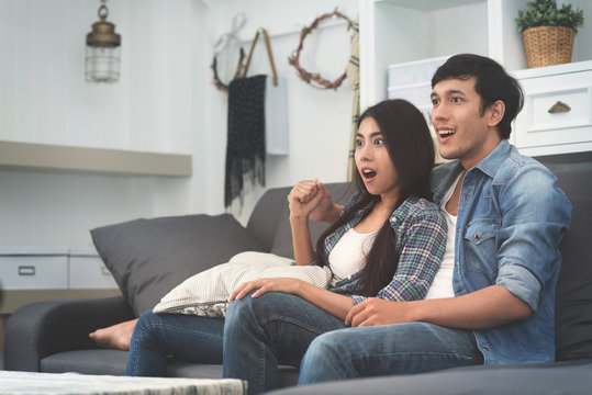 Asian Couple Watching TV.