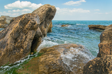 Stones at black sea shoreline above water