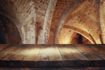 Empty old table in front of ancient knight stone tower. Useful for product display montage