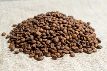 Spilled grains of fragrant coffee close-up.
