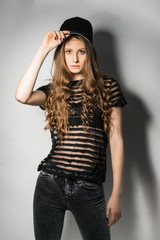 Cheerful model in black cap posing in studio