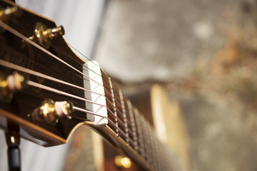 looking down the neck of a leaning guitar 
