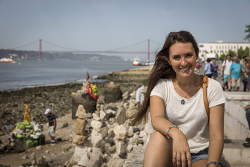 Picture of a woman in front of the landscape of Lisbon, Portugal.