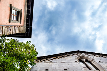 Peculiar view of a palace and a church in Lucca, Italy, from the bottom.
