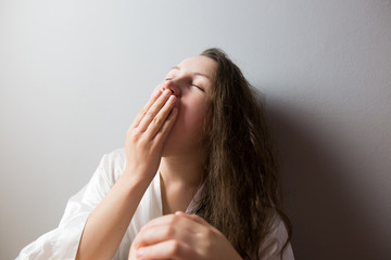 Fototapeta premium Young woman yawing, looking tired